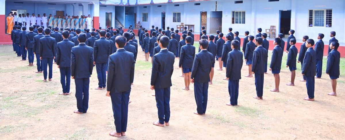 Students standing in formation for the morning assembly at the residential school campus