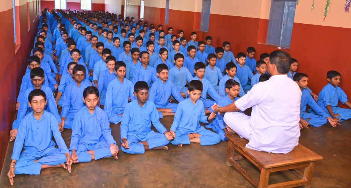 Students in seated meditation during the daily Gurukula routine